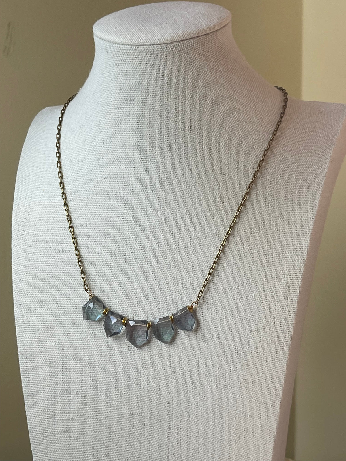 Fluorite gemstone necklace displayed on bust