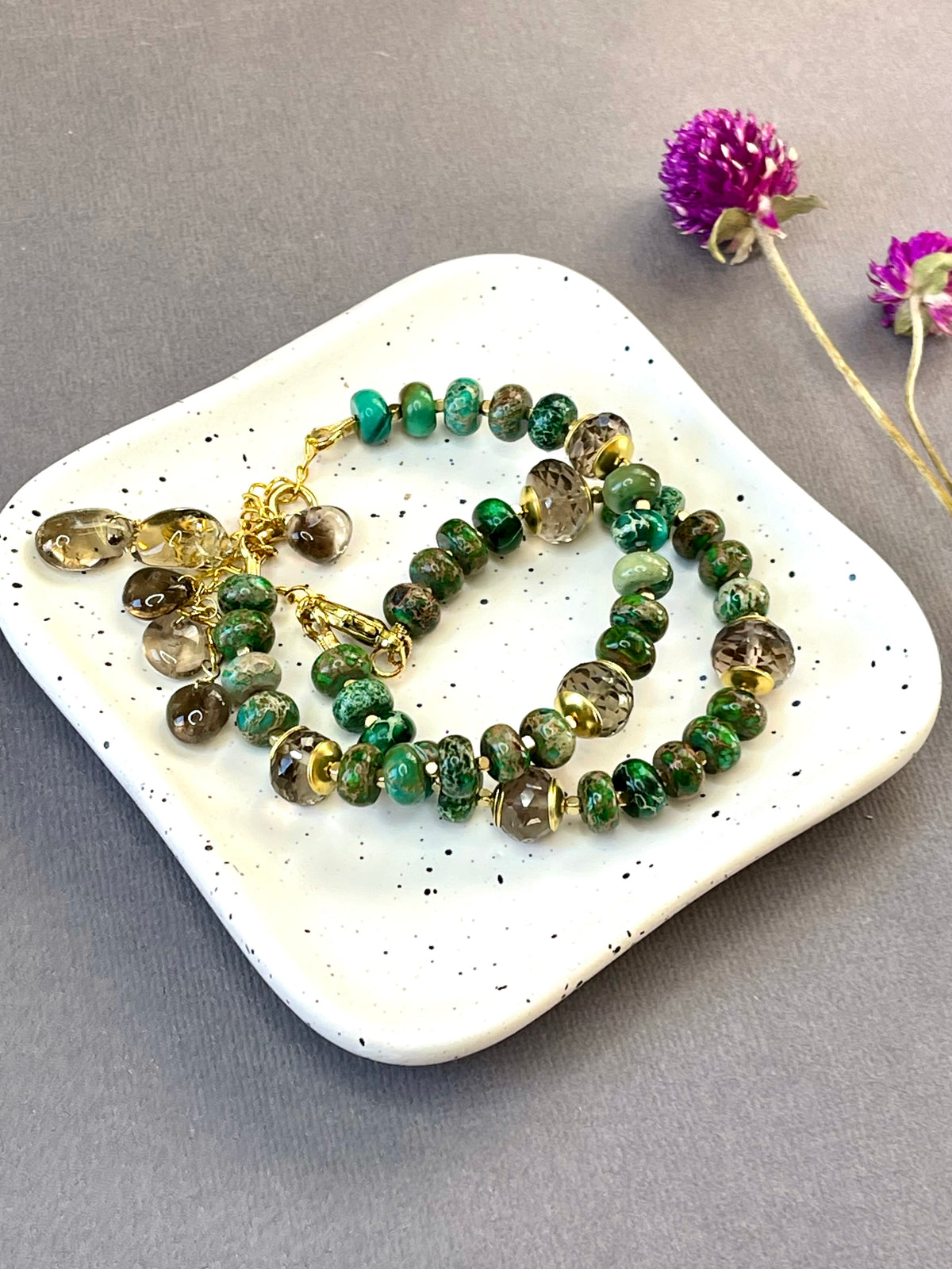 Green imperial jasper and smoky quartz stretch bracelet with gold-plated accents and brass charm