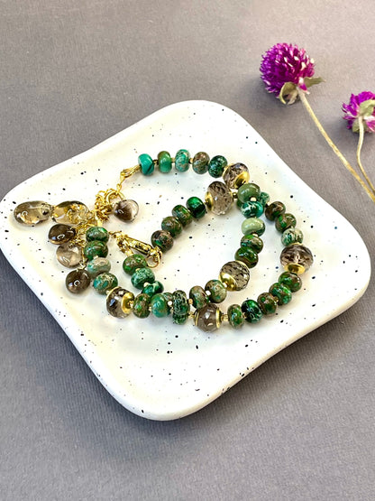 Green imperial jasper and smoky quartz stretch bracelet with gold-plated accents and brass charm