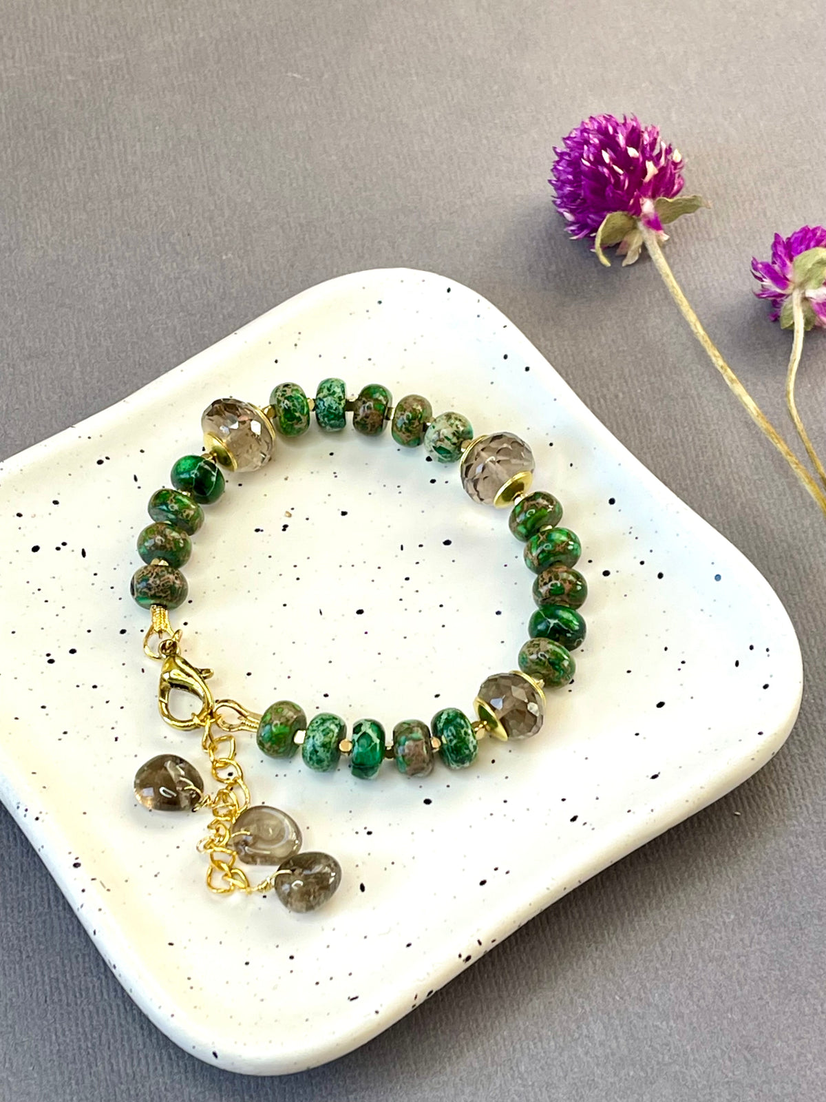 Green imperial jasper and smoky quartz stretch bracelet with gold-plated accents and brass charm