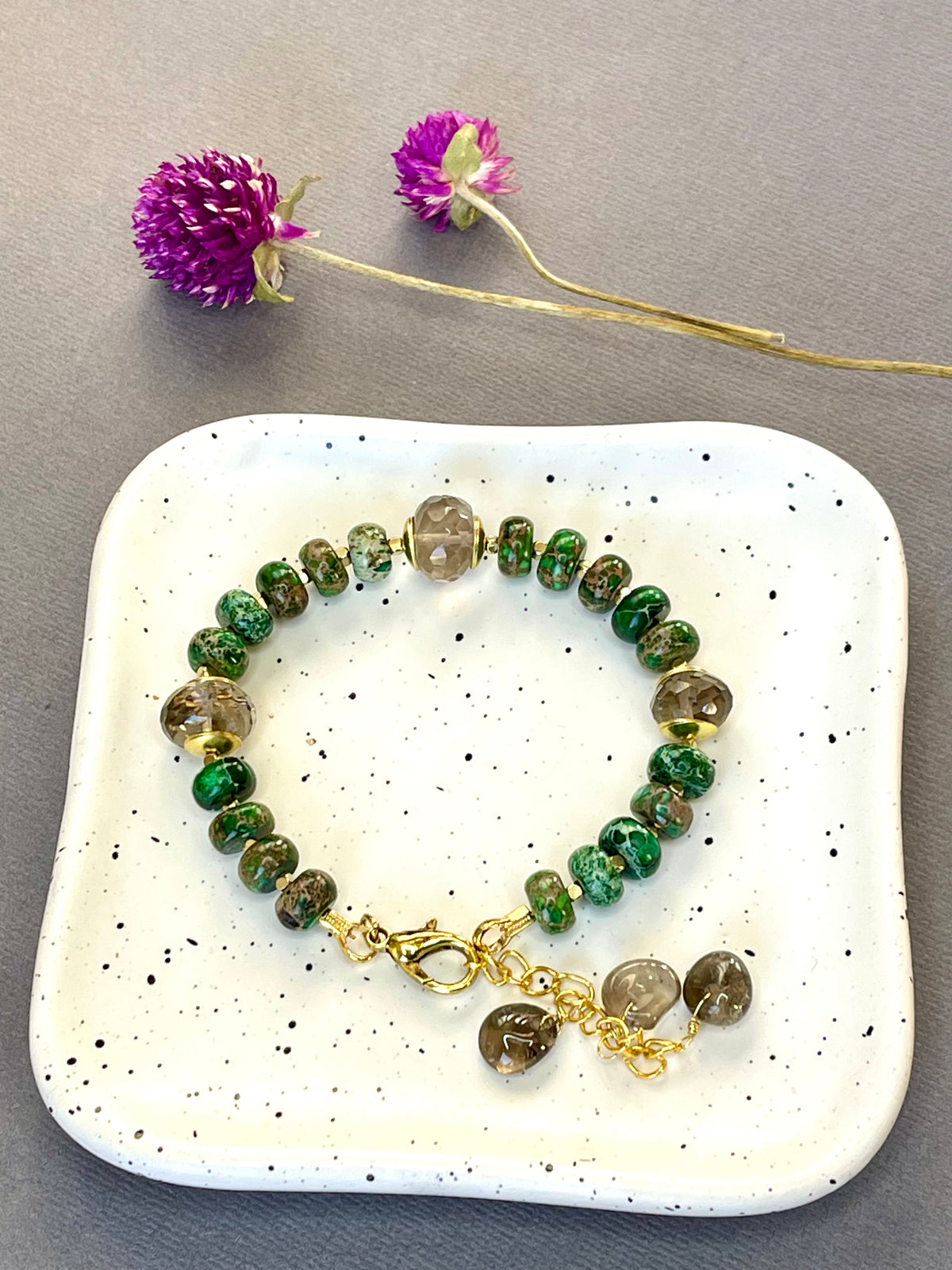 Green imperial jasper and smoky quartz stretch bracelet with gold-plated accents and brass charm