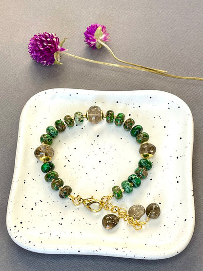 Green imperial jasper and smoky quartz stretch bracelet with gold-plated accents and brass charm