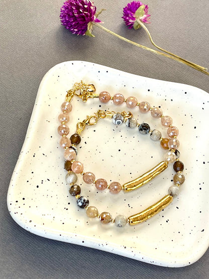 Peach moonstone and spotted agate bead bracelets with textured gold tone bars and adjustable clasps