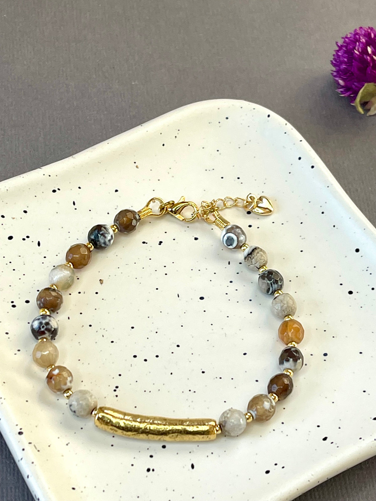 Peach moonstone and spotted agate bead bracelets with textured gold tone bars and adjustable clasps