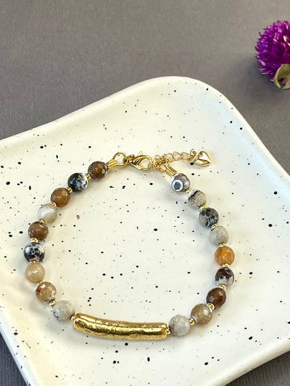 Peach moonstone and spotted agate bead bracelets with textured gold tone bars and adjustable clasps