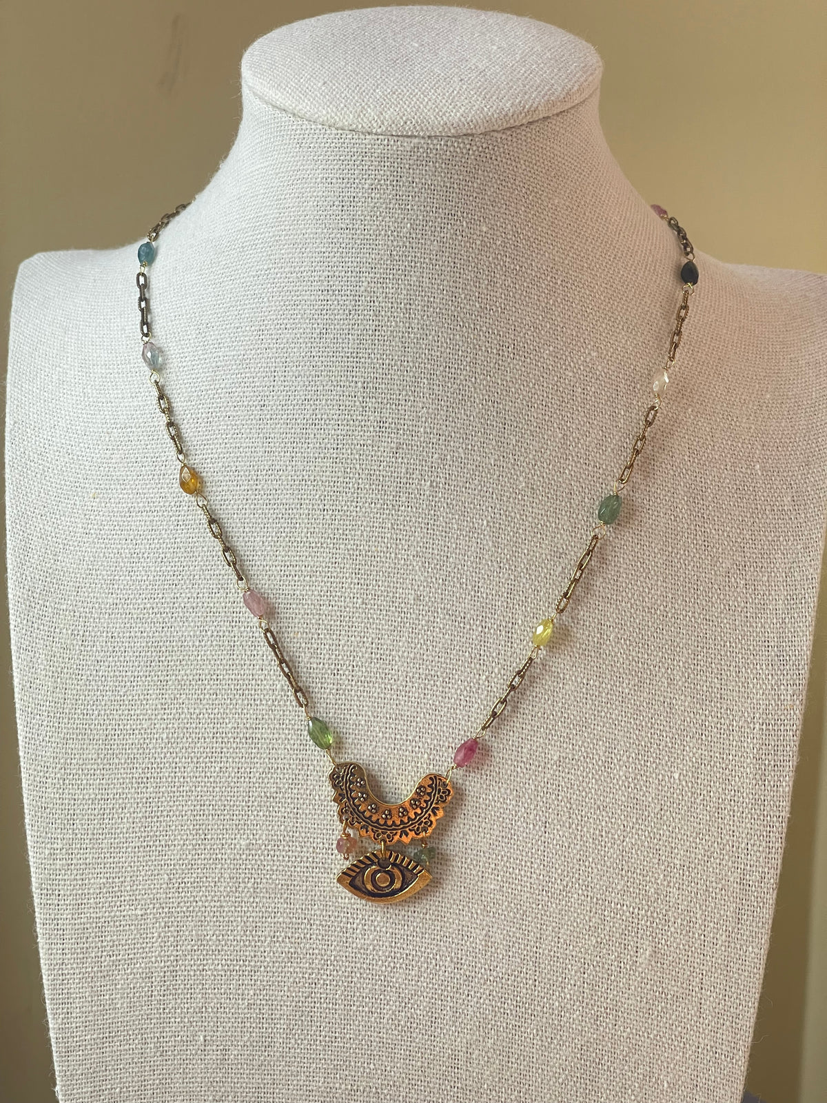 Rainbow tourmaline necklace displayed on bust
