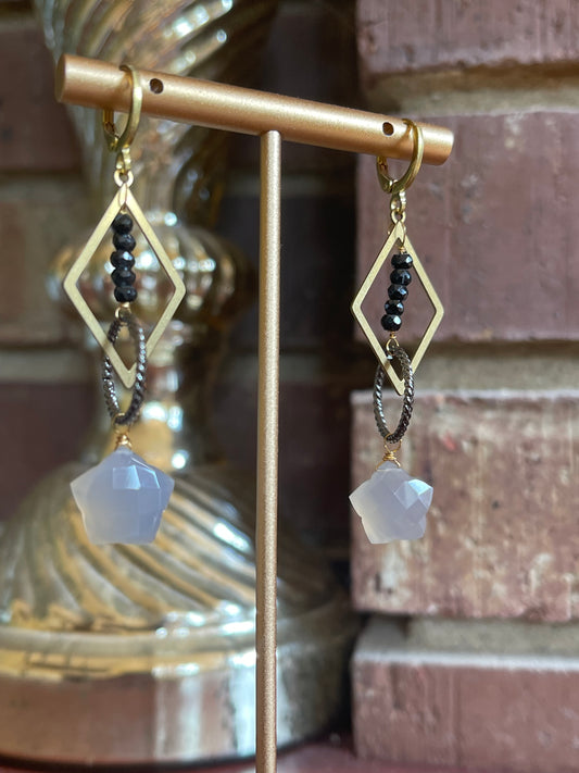 Gray moonstone and black spinel star earrings with geometric brass frames for a modern look
