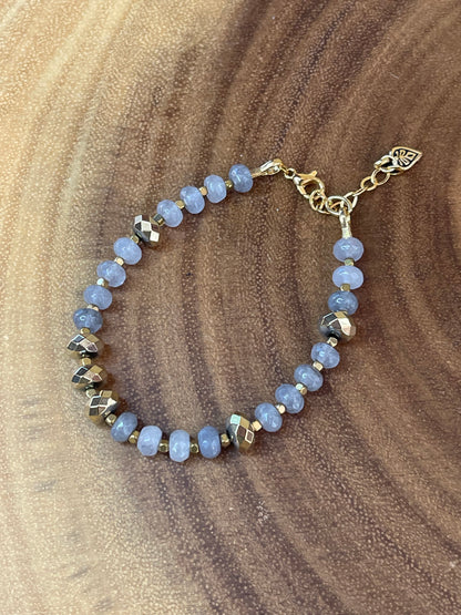 Gray faceted agate and gold hematite beaded bracelet with brass accents, gold plated clasp, and extender chain.