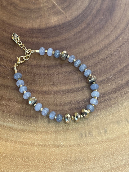 Gray faceted agate and gold hematite beaded bracelet with brass accents, gold plated clasp, and extender chain.