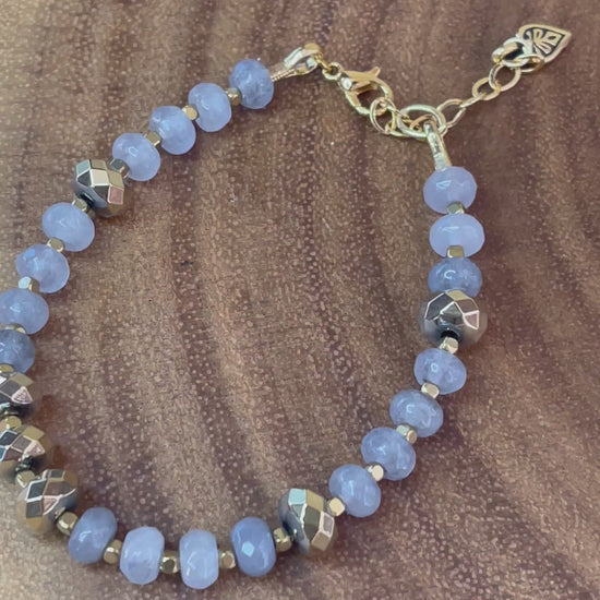 Gray faceted agate and gold hematite beaded bracelet with brass accents, gold plated clasp, and extender chain.