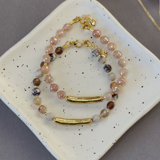 Peach moonstone and spotted agate bead bracelets with textured gold tone bars and adjustable clasps