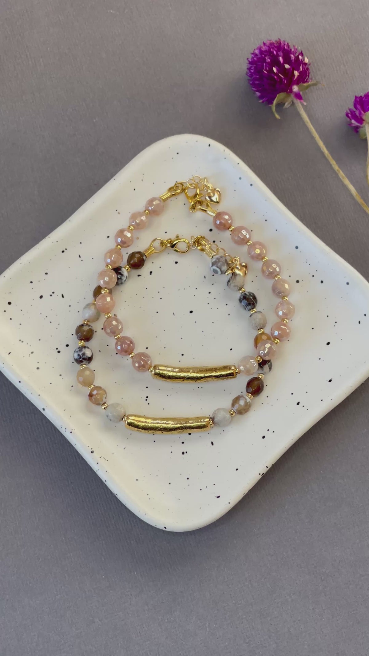 Peach moonstone and spotted agate bead bracelets with textured gold tone bars and adjustable clasps