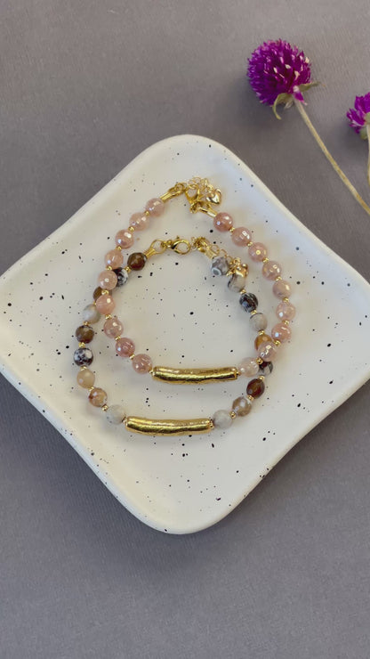 Peach moonstone and spotted agate bead bracelets with textured gold tone bars and adjustable clasps